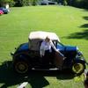 Betsy Young goes for a ride in Custis Harrison's Model A Ford, Preston Young waves goodbye